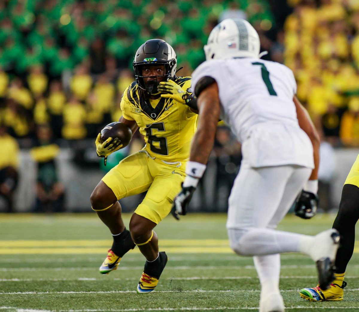 Noah Whittington (6) stares down Nikal Martinez (1) after getting the outside run. University of Oregon takes on Michigan State University at Autzen Stadium, Eugene, October 4th 2024. (Eddie Bruning/Emerald)