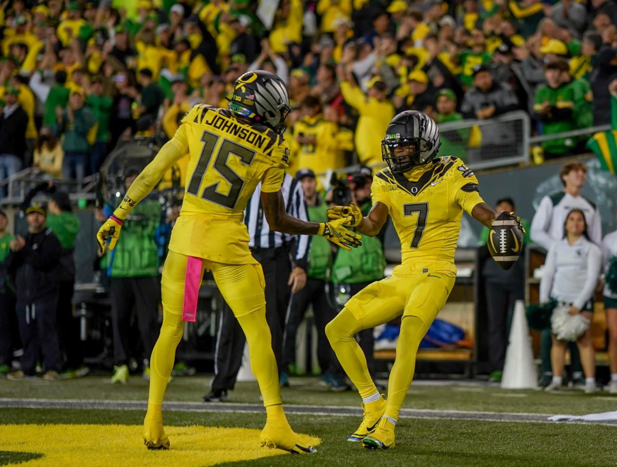 Evan Stewart (7) and Tez Johnson (15) celebrate together after Evan Stewart caught a touchdown right before the end of the first half. University of Oregon takes on Michigan State University at Autzen Stadium, Eugene, October 4th 2024. (Eddie Bruning/Emerald)