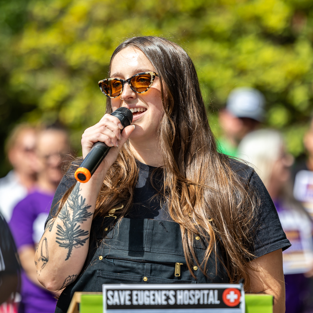 Chelsea Swift, a CAHOOTS service provider, addresses the crowd during a rally at University District Hospital in support of PeaceHealth workers. (Molly McPherson/Emerald)