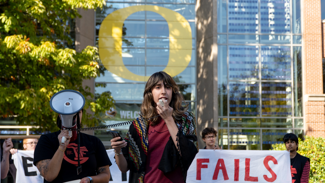 Mae Bracelin, from UO Student Workers (UOSW), delivering a speech in protest of the administration's targeting of free speech to the protestors and onlookers. (Saj Sundaram/Emerald)