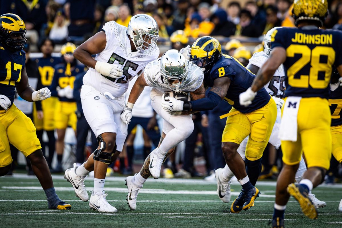 Coming off an appendectomy, Terrence Ferguson (3) picks up right where he left off as Dillon Gabriels go to man. The number 1 ranked Oregon Ducks takes on the Michigan Wolverines on Nov. 2, 2024, at the iconic 'Big House" in Ann Arbor, Mich. (Jonathan Suni/Emerald)