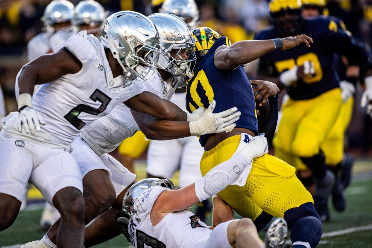 Jordan Burch (1) closes in on the Michigan ball carrier to finish off his teammate's tackle. The number 1 ranked Oregon Ducks takes on the Michigan Wolverines on Nov. 2, 2024, at the iconic 'Big House" in Ann Arbor, Mich. (Jonathan Suni/Emerald)