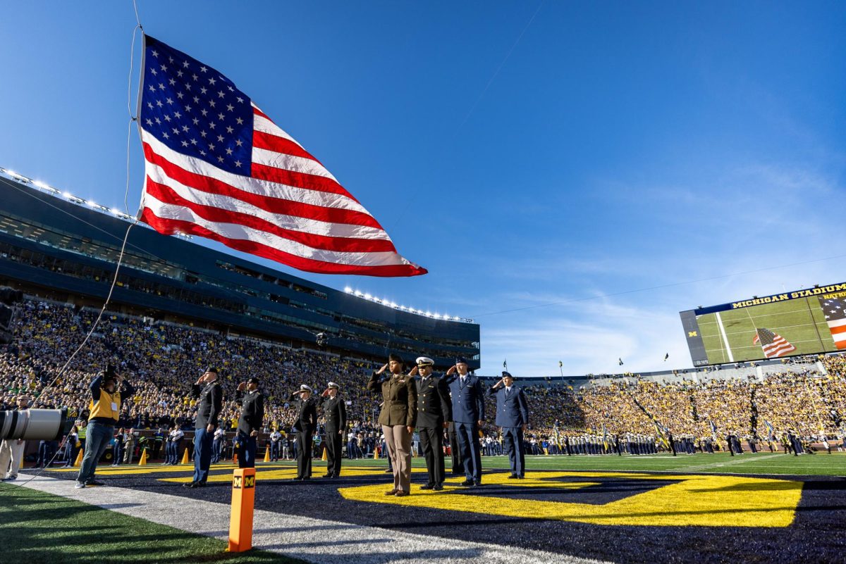 The National Anthem is played as a sold out crowd stands to show respect to the flag as it raises in Michigan Stadium.  The number 1 ranked Oregon Ducks takes on the Michigan Wolverines on Nov. 2, 2024, at the iconic 'Big House" in Ann Arbor, Mich. (Jonathan Suni/Emerald)