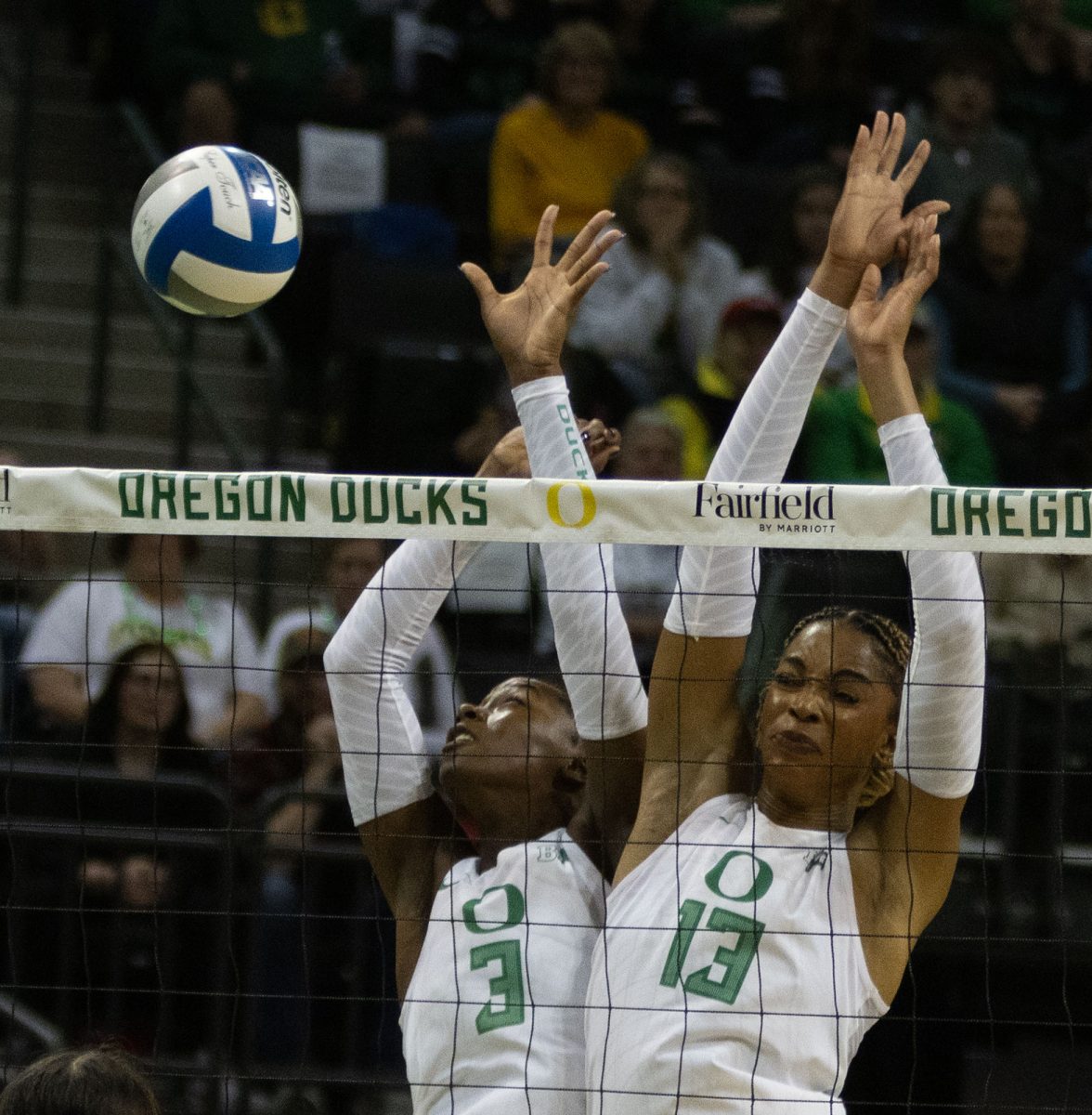 Oregon opposite Noemie Glover (3) and middle blocker Onye Ofoegbu (13) reach towards the ball. The University of Nebraska–Lincoln defeated the University of Oregon Ducks Thursday Nov. 7. Now 17-5 in the season, the Ducks next play the University of Minnesota Golden Gophers Nov. 9. (Miles Cull/Emerald)