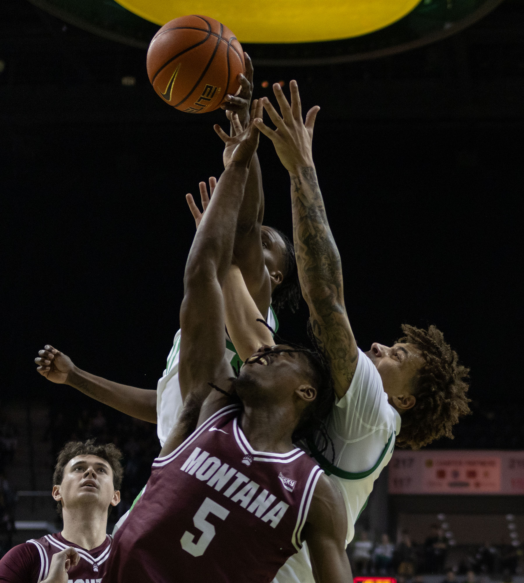 Montana forward Amari Jedkins (5) Oregon forward Mookie Cook (11) and guard Jadrian Tracey (2) fight for control over the ball. The University of Oregon Ducks defeated the University of Montana Grizzlies 79-48 Friday November 8. Now 2-0 in the season, the Ducks go on to play the University of Portland Pilots Tuesday November 12. (Miles Cull/Emerald)