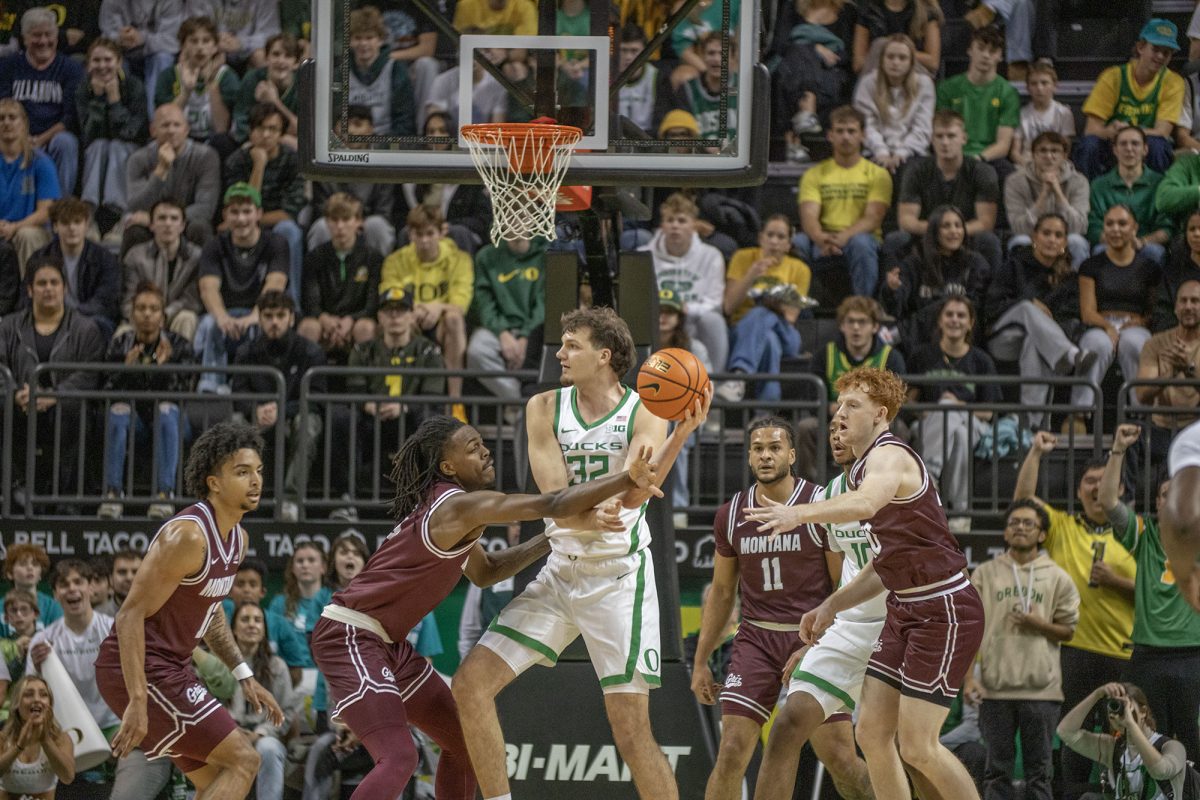 Montana forward Amari Jedkins (5) guards Oregon center Nate Bittle (32). The University of Oregon Ducks Defeated the University of Montana Grizzlies 79-58 on Friday. (Miles Cull/Emerald)