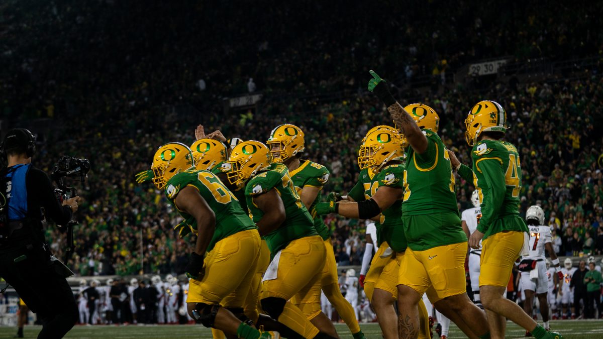 Offensive lineman, Josh Conerly Jr. and teammates celebrating after he took a direct snap and ran for a two-point conversion. The Oregon Ducks played against the Maryland Terrapins at Autzen Stadium in Eugene, Ore. on Nov. 9. (Saj Sundaram/Emerald)