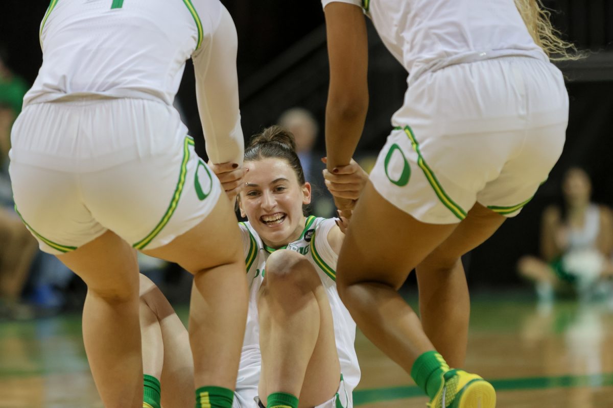 Elisa Mevius (8) draws the charge from a North Texas player and is helped up by her two teammates. The number 25 ranked Oregon Ducks host the North Texas Mean Green at Matthew Knight Arena in Eugene, Ore., on Nov. 12, 2024. (Julia Massa/Emerald)