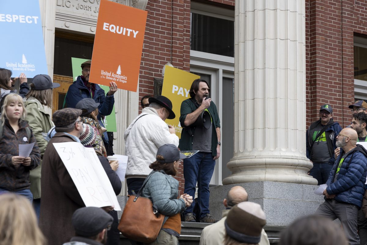 Mike Urbancic, United Academics president, speaks to demonstrators at a rally at Johnson Hall in support of the University of Oregon United Academics on Nov. 13, 2024. After the rally, demonstrators marched to Chiles Hall, where UO and UA teams met for a bargaining session. (Alex Hernandez/Emerald)