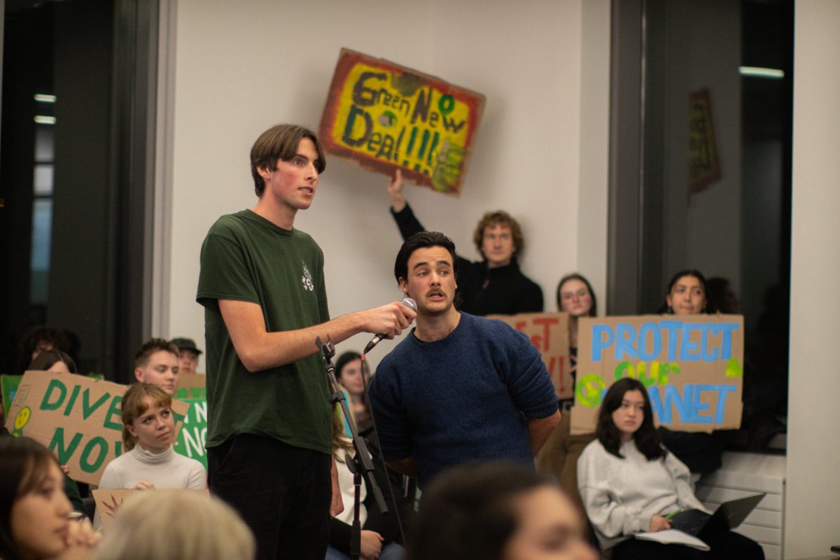 Jack Dodson and Declan Zupo read off their keynotes before addressing the complete proposal. Green New Deal supporters present their proposal to the ASUO Senate on Nov. 13, 2024. (Mason Cruz/Emerald)