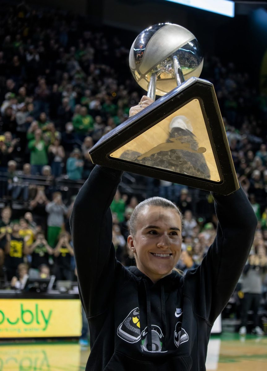 New York Liberty guard, and University of Oregon Alumni, Sabrina Ionescu holds up the Women’s National Basketball Association Championship trophy in Matthew Knight Arena during the Oregon vs. Baylor women’s basketball game, Sunday night. 