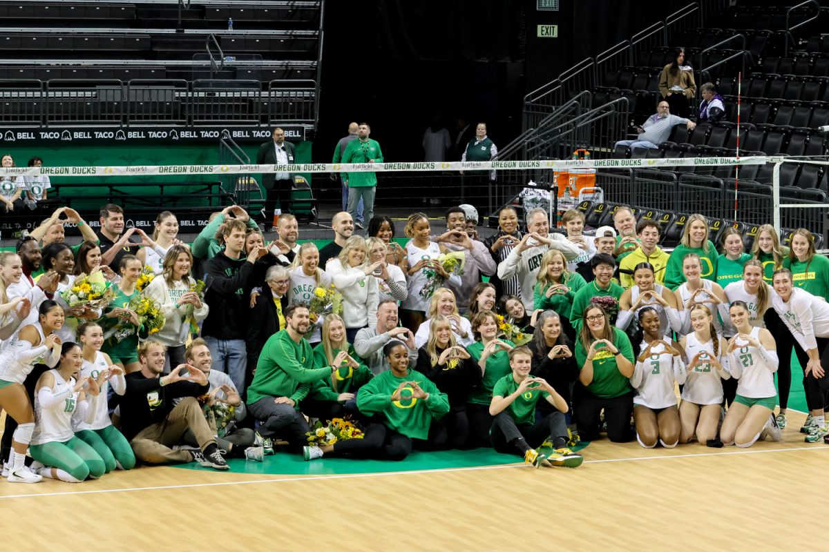 The Oregon women's volleyball family gathers midcourt after recognizing its seniors. The University of Oregon women's volleyball team defeat the Northwestern University Wildcats (3-1) in a home match at Matthew Knight Arena in Eugene, Ore., on Nov. 15, 2024. (Julia Massa/Emerald).