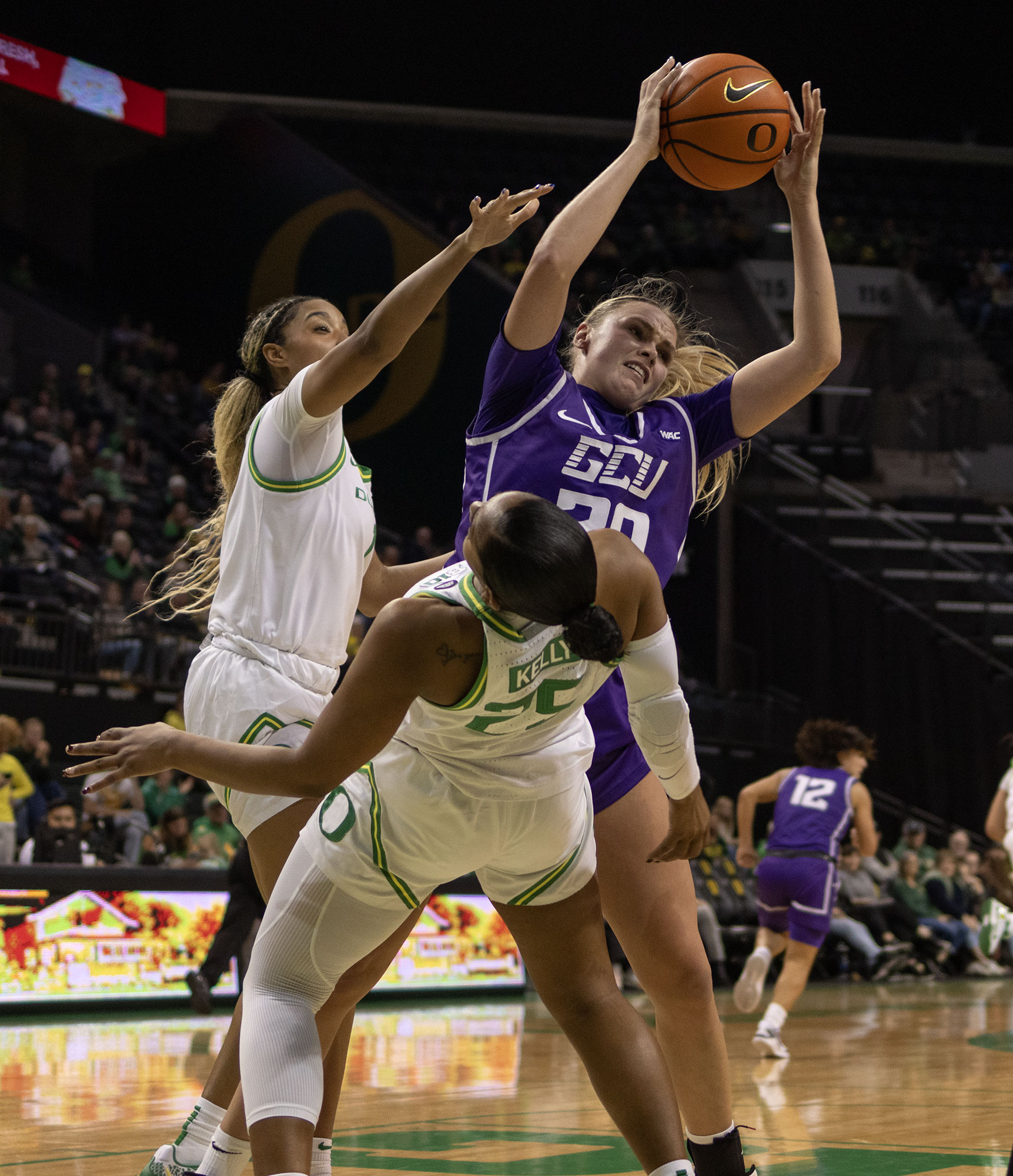 Oregon guard Deja Kelly (25) is knocked over after screening Grand Canyon forward Laura Erikstrup (20). The University of Oregon Ducks defeated the Grand Canyon University Antelopes 70-54 on Monday, November 18. Now 5-0 in the season, the Ducks will play the Auburn University Tigers on November 20.