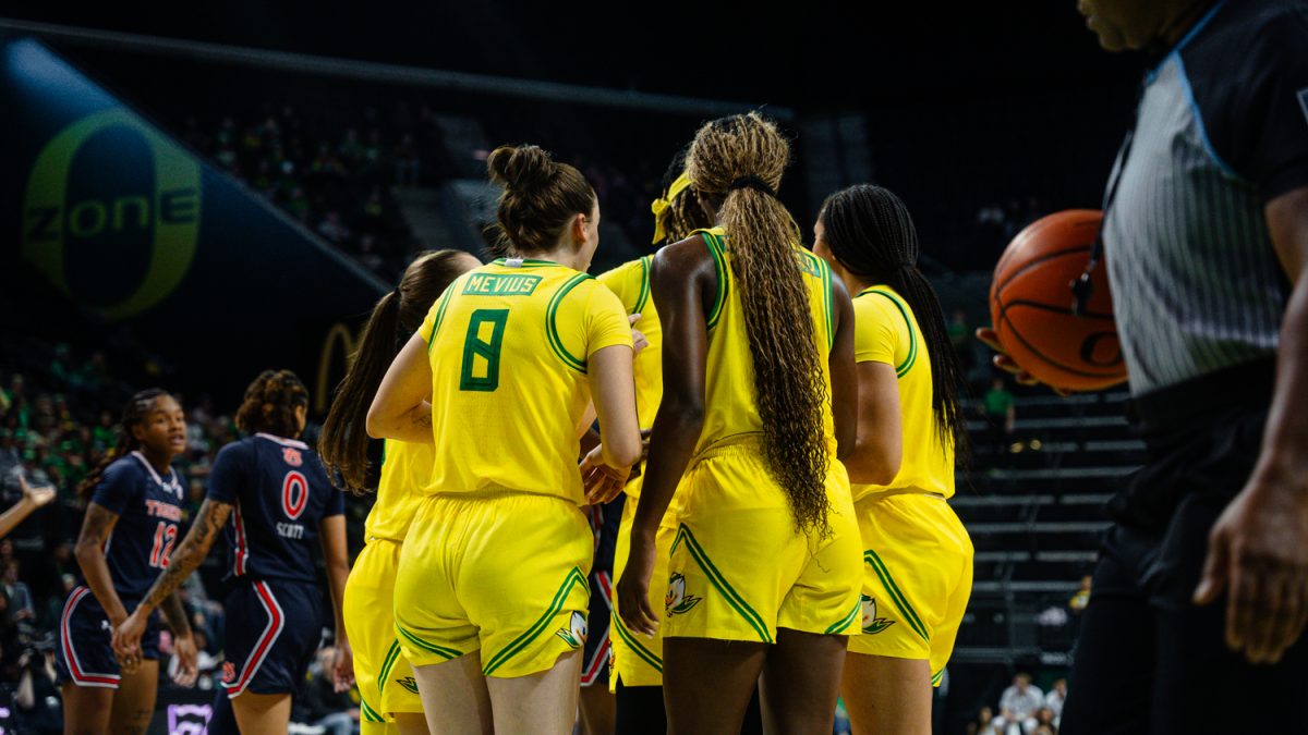 The Oregon Ducks huddle together to strategize their next steps at Matthew Knight Arena in Eugene, Ore. on Nov. 20, 2024 (Jordan Martin/Emerald)