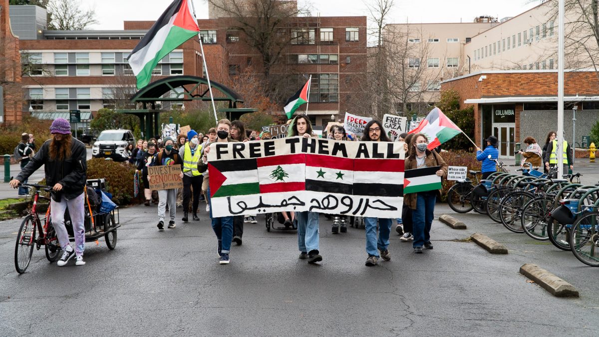 At noon on Nov. 21, some University of Oregon students, faculty and Eugene community members met at the Erb Memorial Union Amphitheater to begin their “walk-out” for an "International Day of Action." (Saj Sundaram/Emerald)