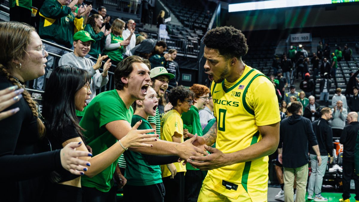 Ra'Heim Moss gets hyped with fans, celebrating the Ducks win in OT on Nov. 12, 2024, in Eugene, Ore. (Jordan Martin/Emerald)