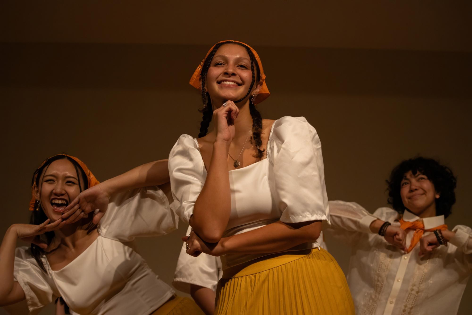 Izzy Chew (left), Sydney Lackey (center), and Aaralyn Reed (right) perform Itik-Itik, which is a traditional Filipino dance, and was the last performance of Fil-Am. The University of Oregon Kultura Pilipinas  club had their Fil-Am fall showcase, Sunday Evening Nov. 17, 2024, in Global Scholars Hall Great Room, Eugene, Ore. 