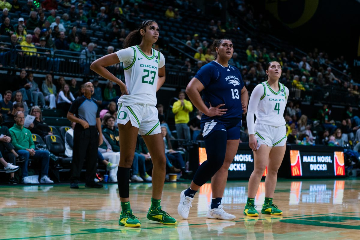 Amelia Raidaveta (13), Sarah Rambus (23), and Nani Falatea (4) wait at the free throw line. The University of Oregon Ducks Women's Basketball team defeated the University of Nevada Wolf Pack 76-58 in a home game at Matthew Knight Arena in Eugene, Ore., on Nov. 6, 2024. (Rowan Campbell/Emerald)