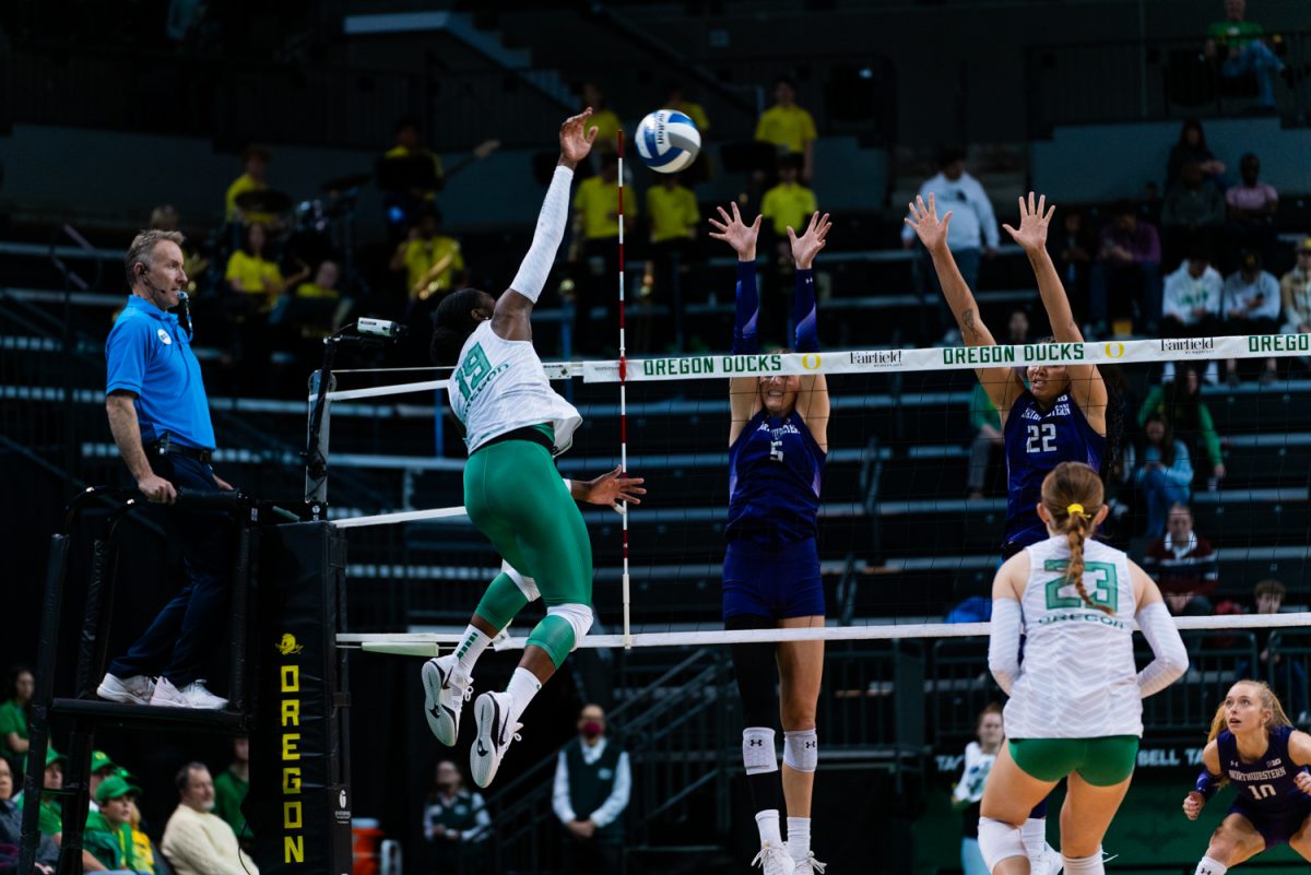 Michelle Ohwobete (19) mid kill. The University of Oregon Ducks Women's Volleyball team defeat the Northwestern University Wildcats (3-1) in a home match at Matthew Knight Arena in Eugene, Ore., on Nov. 15, 2024. (Rowan Campbell/Emerald).