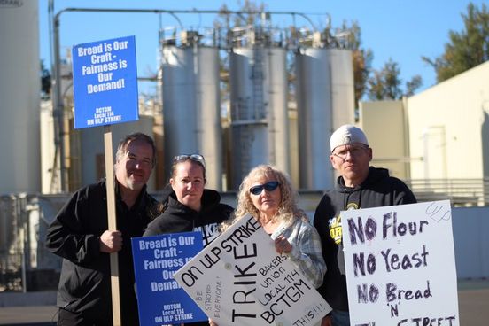 Local 114 union members picket in front of the Franz Bakery industrial packaging and distribution facility. (Mathias Lehman-Winters/ Emerald) 