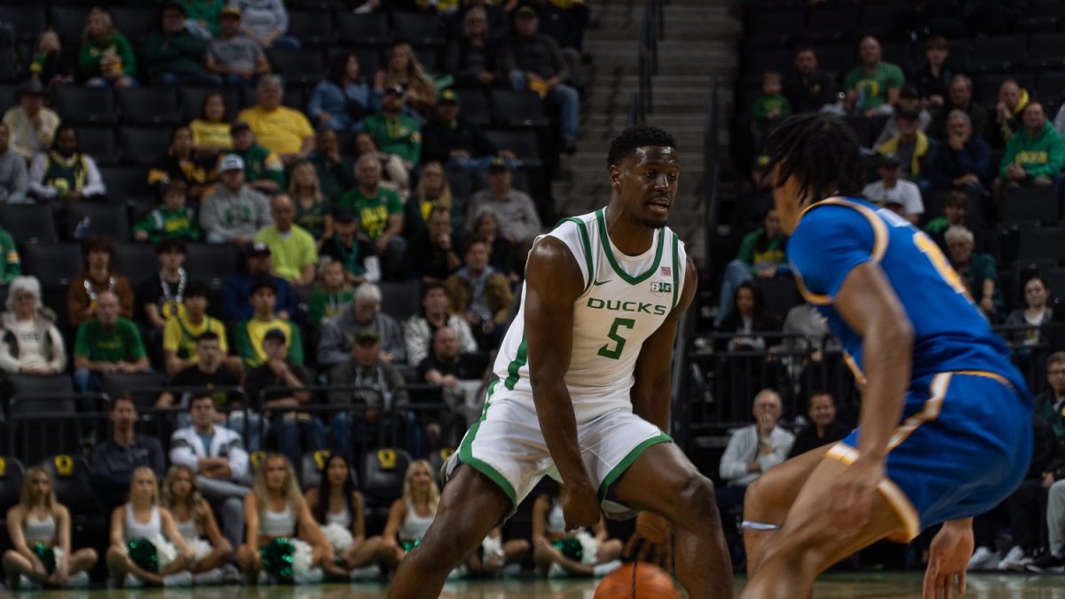 TJ Bamba, a guard for the Oregon Ducks Men's Basketball, crossing up a guard from UC Riverside, just before passing the ball to a teamate to make a shot. (Saj Sundaram/Emerald)