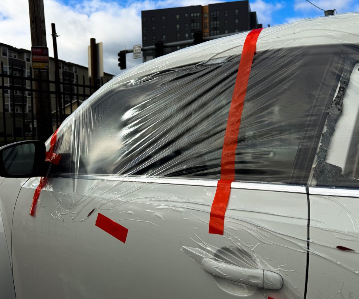 Car parked in a lot between the 515 and 959 has a trash bag covering a broken window. (JR Quint /Emerald)