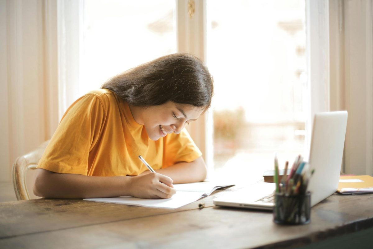 https://www.pexels.com/photo/woman-in-yellow-shirt-writing-on-white-paper-3807755/