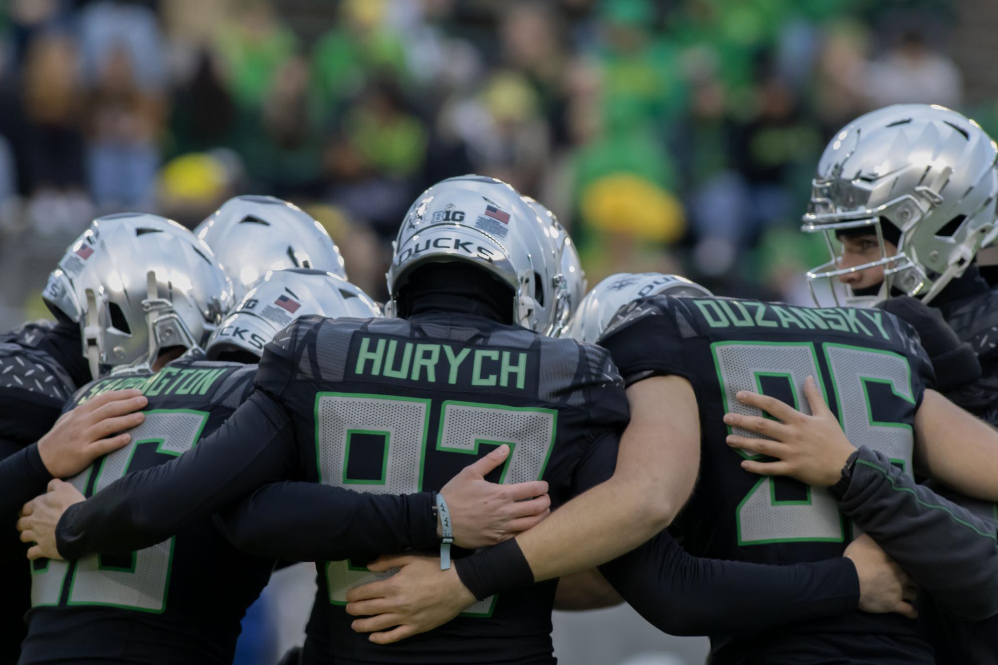 Atticus Sappingtion (36), Gage Hurych (97), and Nick Duzansky (96) huddle with other teammates before kickoff. No. 1 Oregon defeats Washington 49-21 for an undefeated regular season at Autzen Stadium on Nov. 30, 2024. (Alyssa Garcia/Emerald) 

