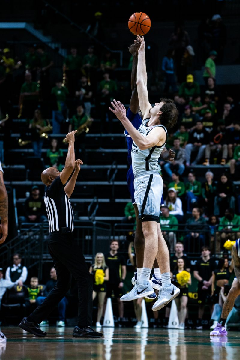 Nate Bittle (32) reaching for the ball at tip off. The University of Oregon Ducks Mens Basketball team defeat the SFA Lumberjacks (79-61) in a home match at Matthew Knight Arena in Eugene, Ore., on Dec. 15, 2024. (Rowan Campbell/Emerald).