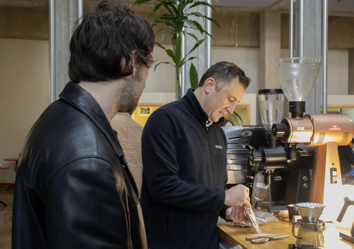 Chris Hendon demonstrates to a student worker how to brew a coffee at Hendon Coffee Lab at the University of Oregon campus. (Alyssa Garcia/Emerald)
