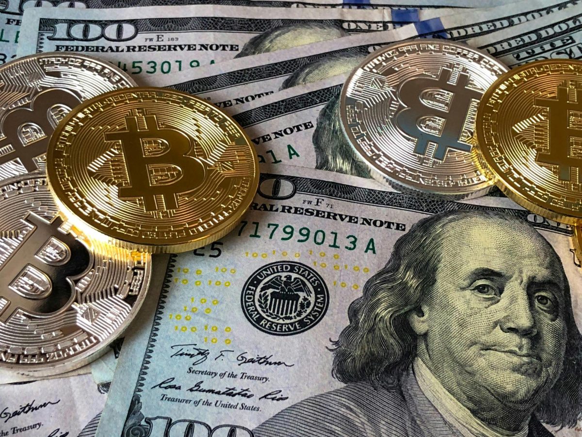 https://www.pexels.com/photo/bitcoins-and-u-s-dollar-bills-730547/