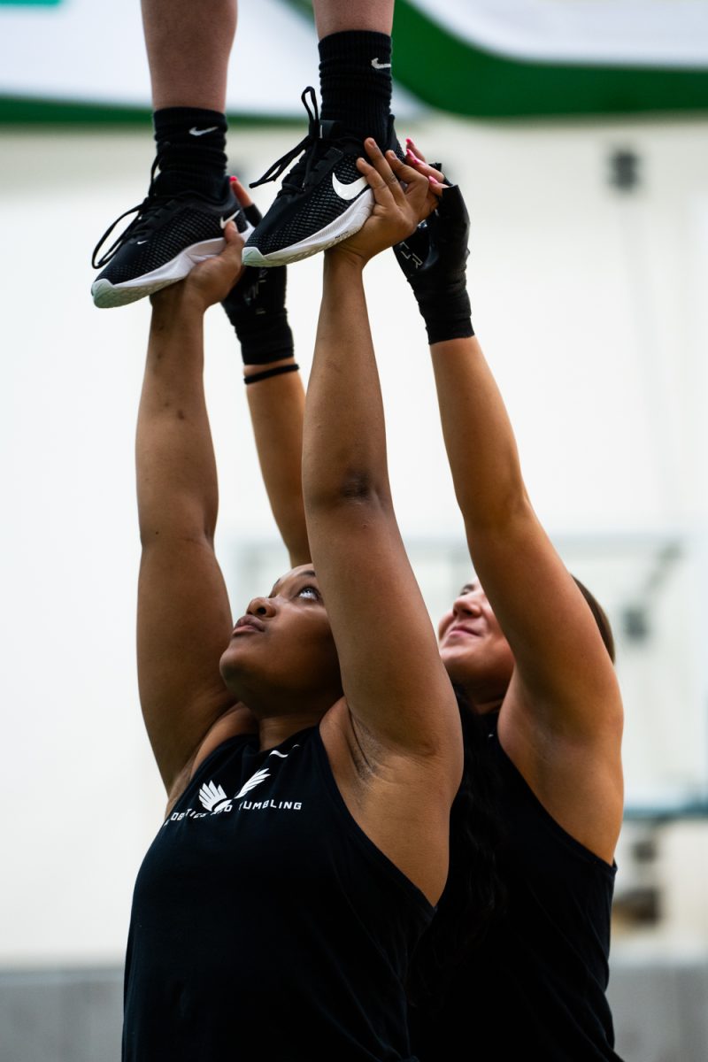Blessyn Mcmorris (22) mid routine. The University of Oregon Ducks Acrobatics and Tumbling team practices at Matthew Knight Arena in Eugene, Ore., on Feb. 6, 2025. (Rowan Campbell/Emerald).