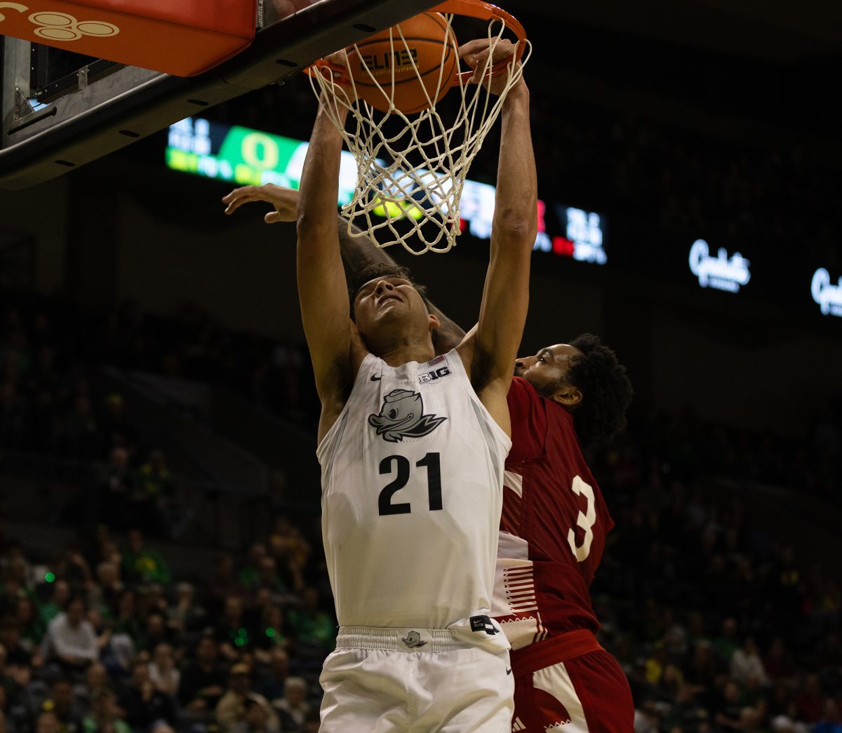 Oregon forward Brandon Angel (21) hangs off the net. The University of Nebraska–Lincoln Cornhuskers defeated the University of Oregon Ducks 77-71. Now 16-6 in the season, the Ducks will go on to face Michigan Wolverines on February, 5. (Miles Cull/Emerald)