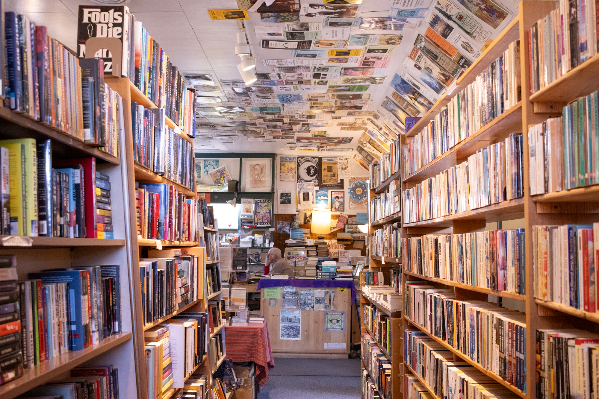 Owner of Tsunami Books, Scott Landfield, sorts a stack of childrens books that the store may buy from a customer. Tsunami Books is an independent bookstore selling a wide selection of used and new titles located in Eugene, Ore. They also sell various artwork made by different artists, and will hold community events, and shows year around.