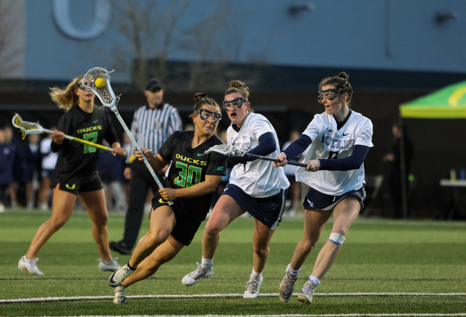 Ducks middie, Anna Simmons (30), cuts past her defenders to get a shot on goal. The Oregon Ducks take on the Butler Bulldogs in their home opener at Pape Field in Eugene, Ore. on Feb. 7, 2025. (Julia Massa/Emerald)