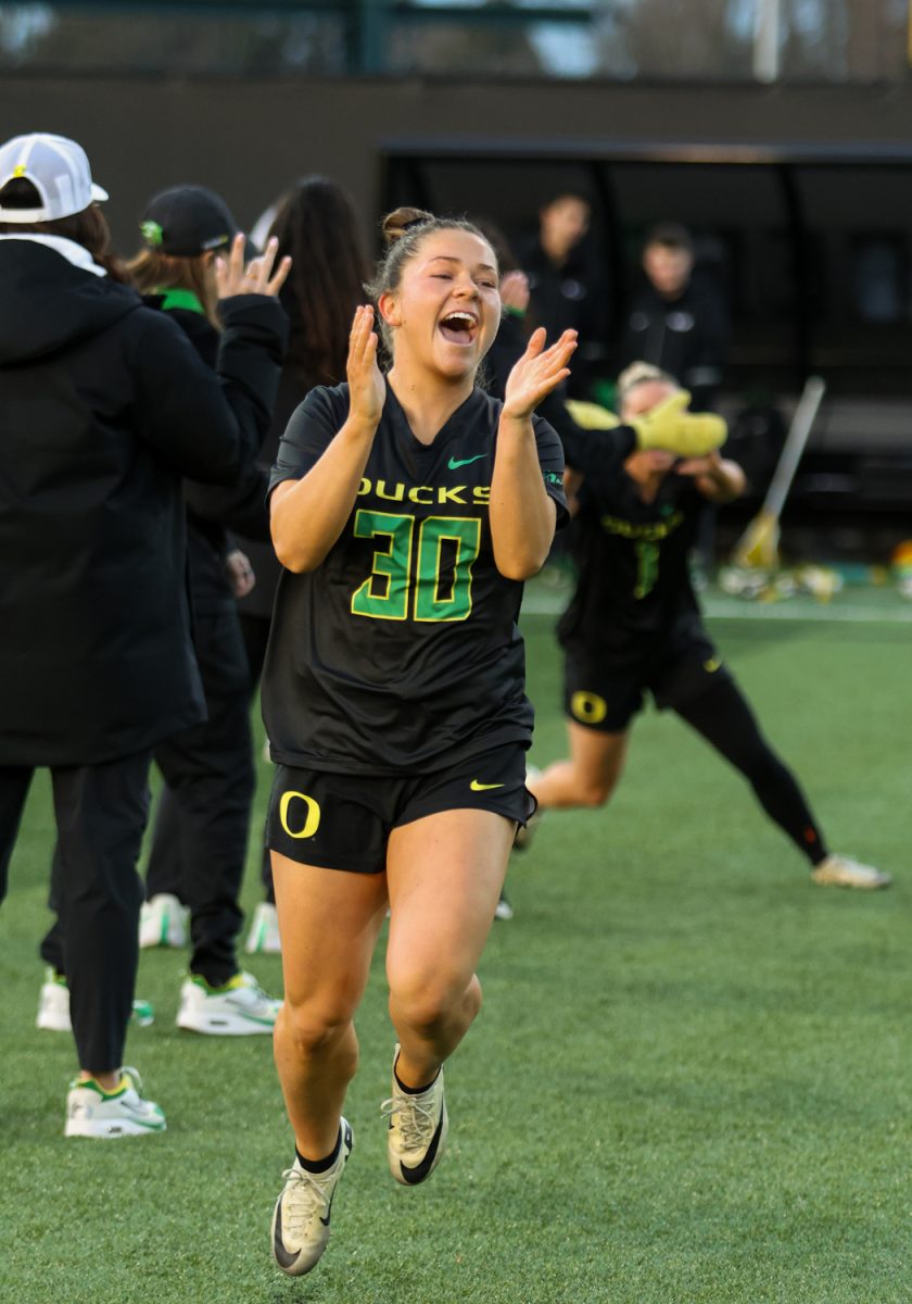 Anna Simmons (30) getting excited as the Ducks players are announced prior to the face off. The Oregon Ducks take on the Butler Bulldogs in their home opener at Pape Field in Eugene, Ore. on Feb. 7, 2025. (Julia Massa/Emerald)