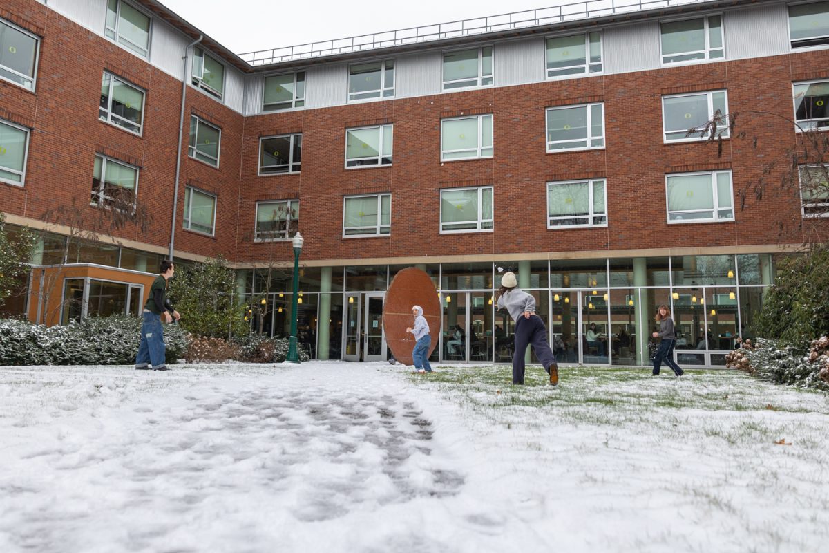 A snowball fight breaks out outside LLC. An overnight snowfall coats Eugene and the University of Oregon in a blanket of white on Feb. 13, 2025. (Molly McPherson/Emerald)