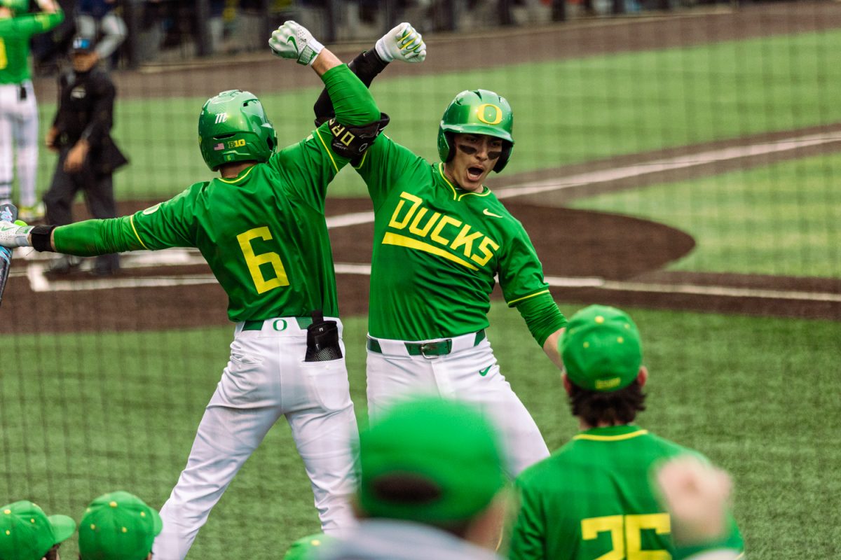 Oregon Ducks catcher Anson Aroz celebrates with teammate Jack Brooks after hitting homerun. Oregon baseball take on the Rhode Island Rams at PK Park in Eugene, Ore. on Feb. 21, 2025. (Eduardo Garcia/Emerald)