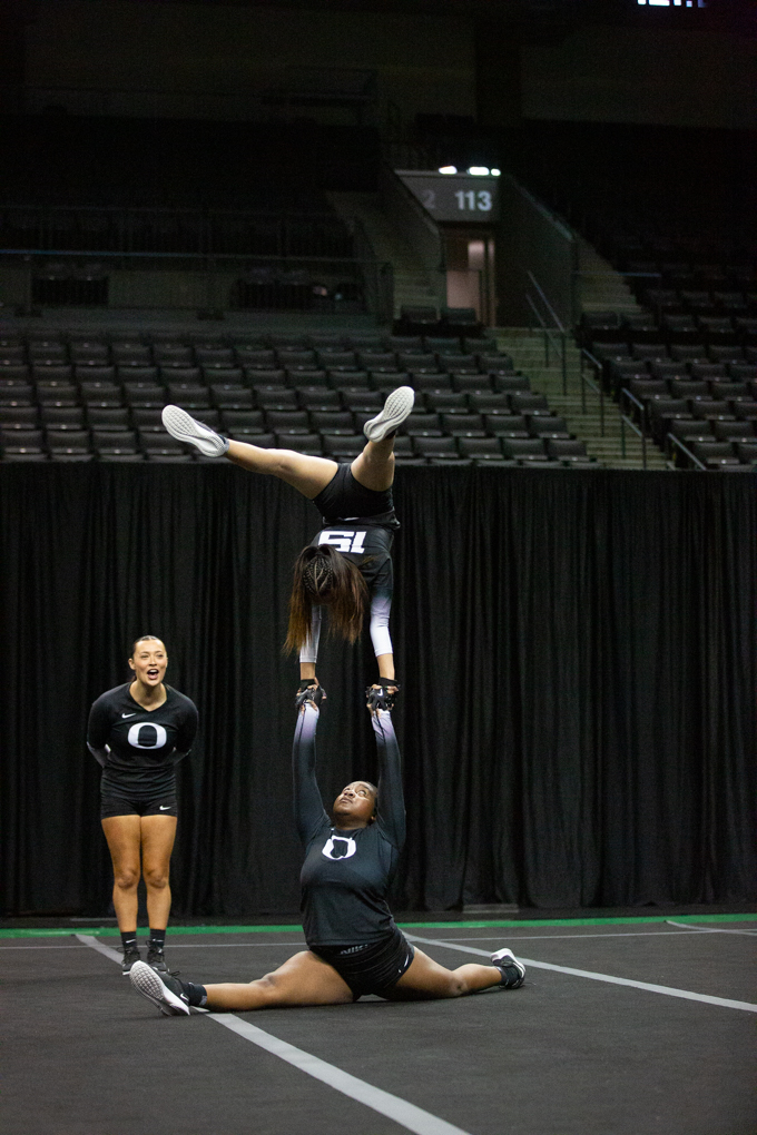 Oregon base Angelica Martin (No. 59, bottom) and top Cassidy Cu (No. 19, top) compete their five-element acro skill