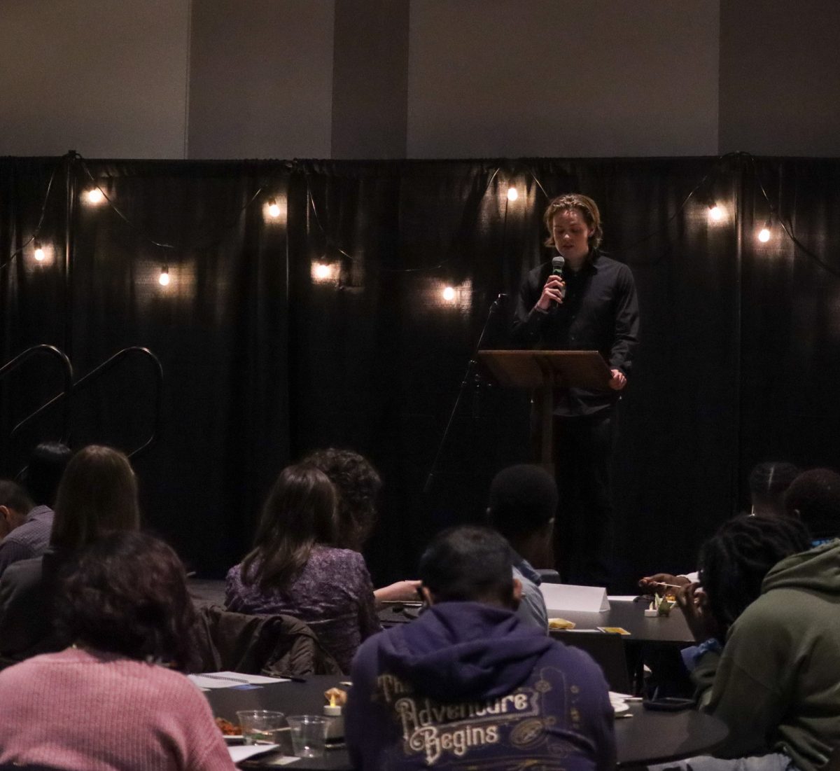 Ryan Pearl reads their poem “In Rainbows.” Students, staff, and community members came to participate in the reading and listening of poetry. The University of Oregon Mills International Center hosted World Poetry Night Tuesday evening, February 28, 2025.