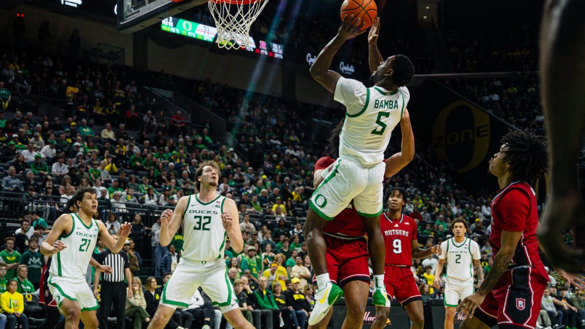 TJ Bamba (5) rises over the defender for a layup in their game against Rutgers Feb. 16, 2025, in Eugene, Ore. (Jordan Martin/Emerald)