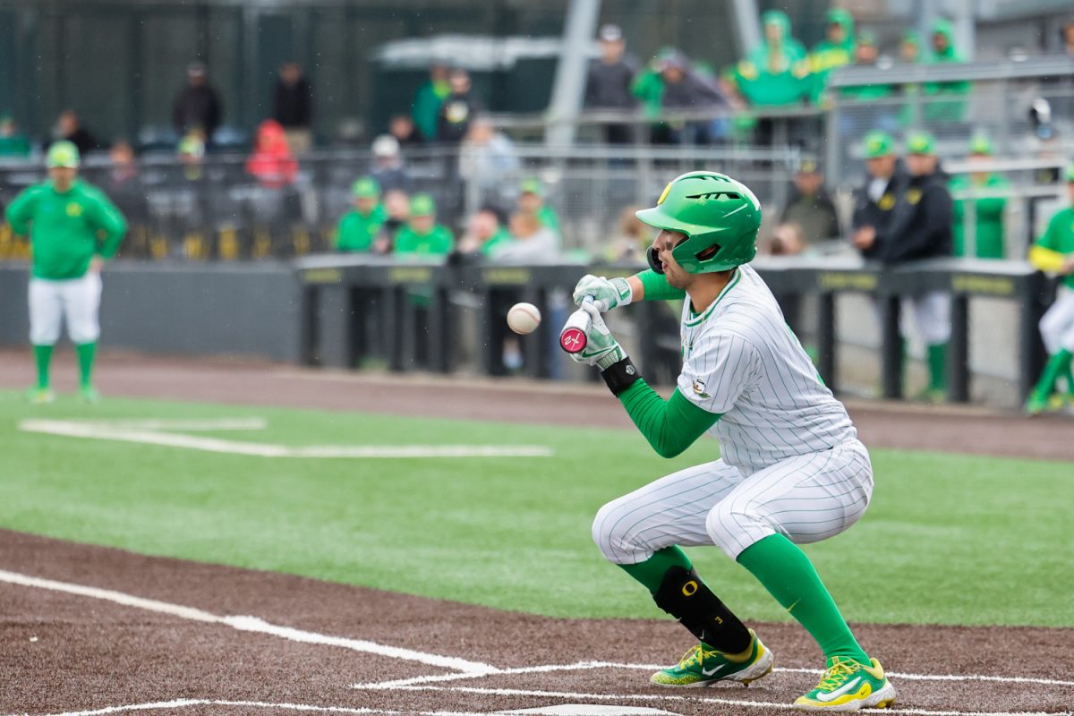 Carter Garate (3) bunts, The Oregon Ducks take on the Rhode Island Rams on Febuary 22nd at PK Park in Eugene, Ore. (Darby Winter/Emerald)