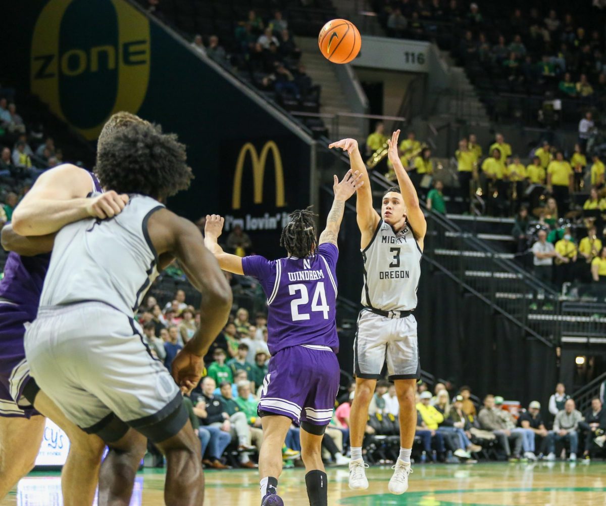 Jackson Shelstad (3) shoots a three over K.J. Windham (24). Oregon Men’s Basketball takes on Northwestern in Eugene, Ore. on Feb. 11, 2025