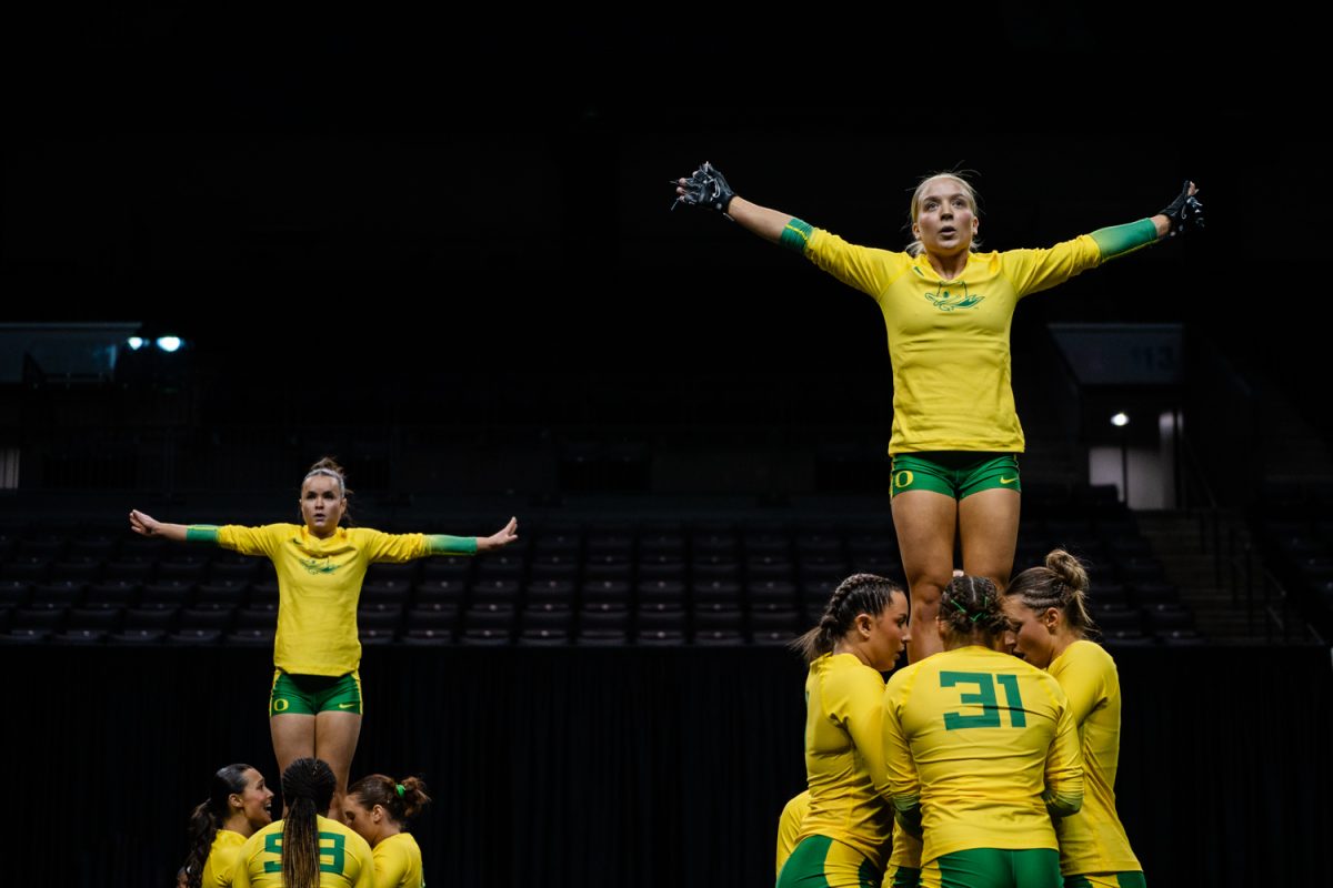 Rachel Furlong (18) and Haley Ellis (41) extend at the top of the routine during the final performance. The University of Oregon Ducks Women’s Acrobatics and Tumbling team in a home match against Morgan State at Matthew Knight Arena in Eugene, Ore., on Feb. 15, 2025. (Rowan Campbell/Emerald).