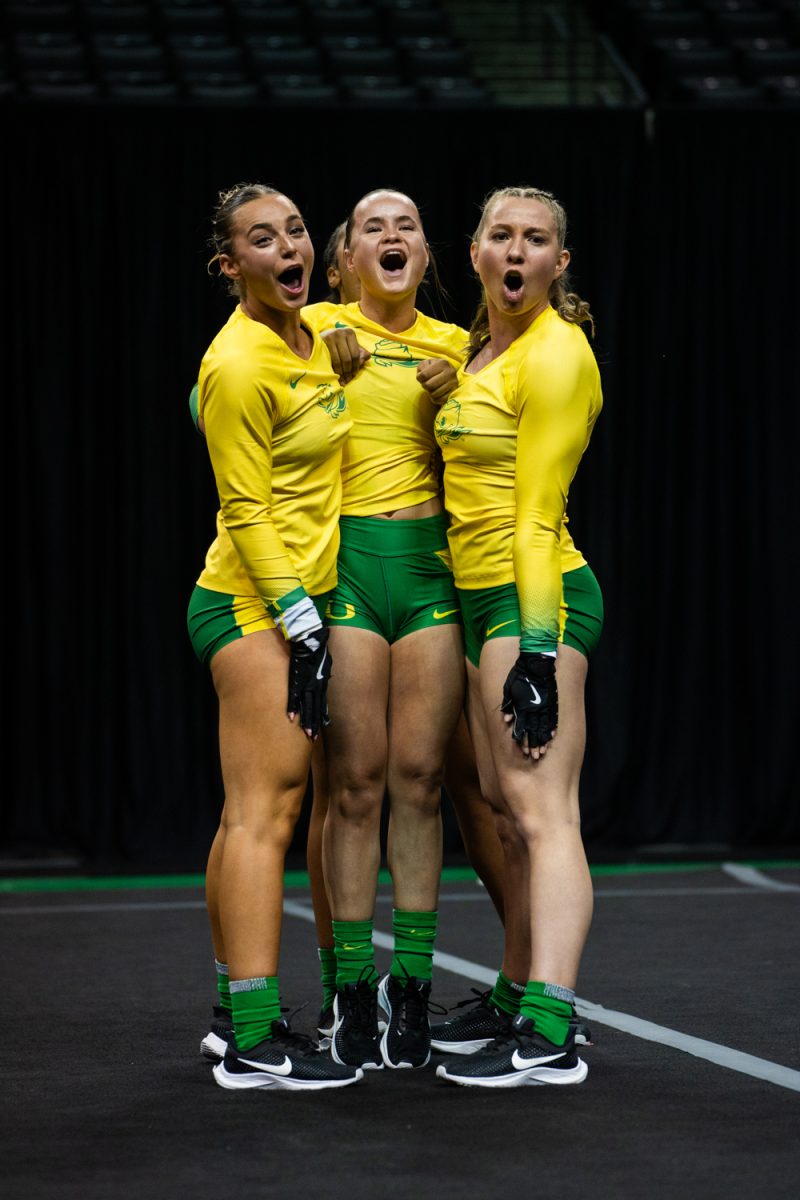 Oregon athletes shouting to conclude the routine. The University of Oregon Ducks Women’s Acrobatics and Tumbling team in a home match against Morgan State at Matthew Knight Arena in Eugene, Ore., on Feb. 15, 2025. (Rowan Campbell/Emerald).