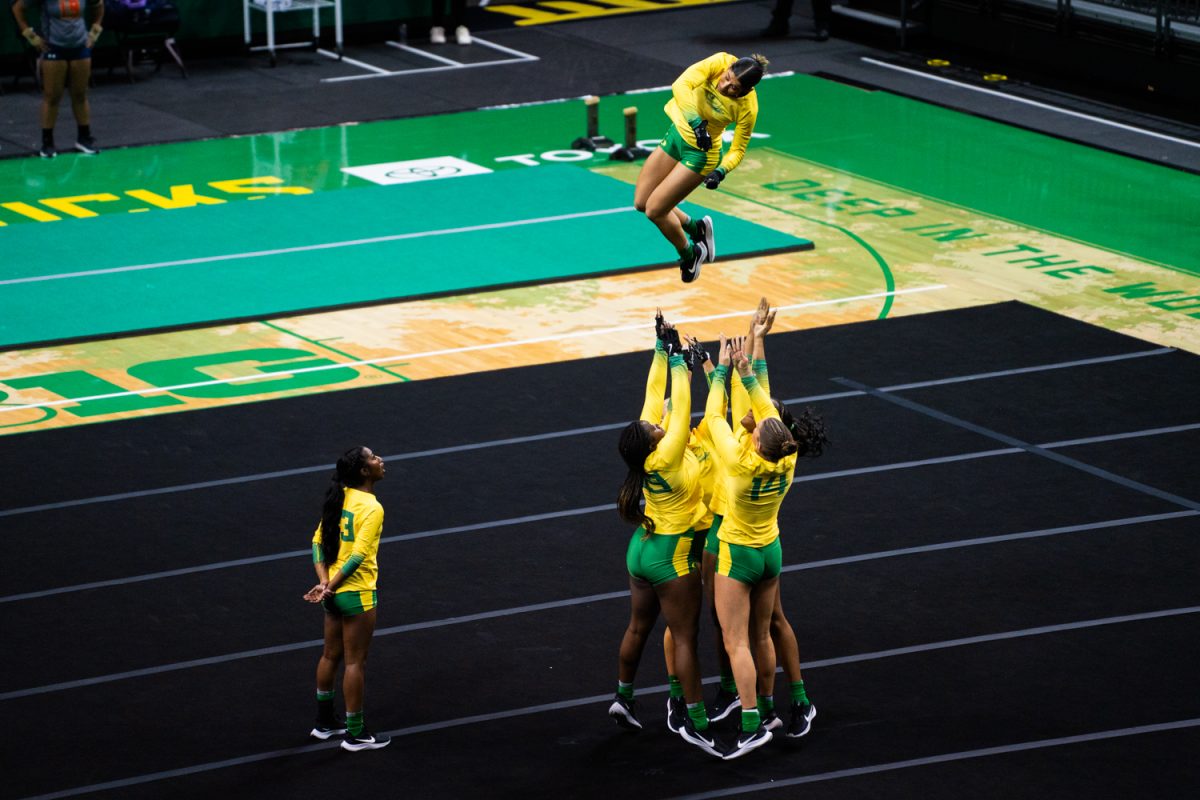 Alexis Giardina (29) is thrown into the air during the routine. The University of Oregon Ducks Women’s Acrobatics and Tumbling team in a home match against Morgan State at Matthew Knight Arena in Eugene, Ore., on Feb. 15, 2025. (Rowan Campbell/Emerald).