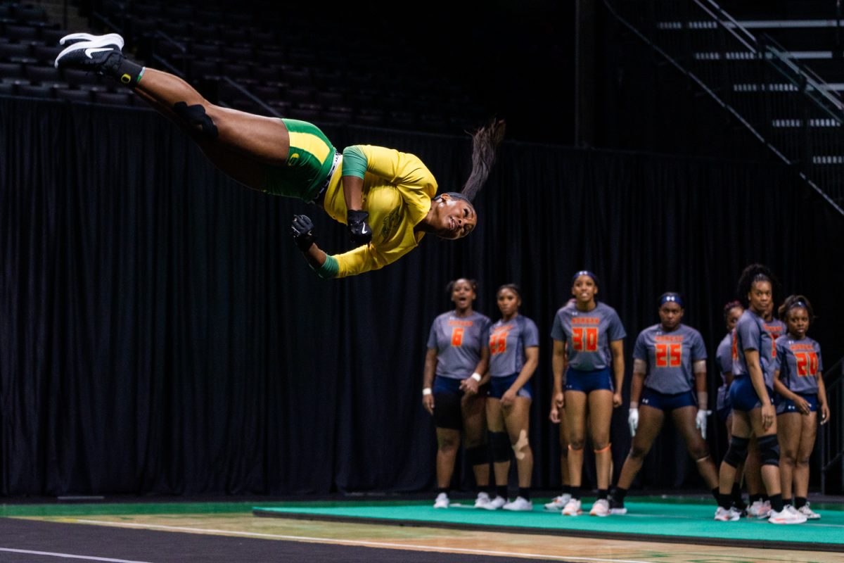 Morgan State watches as Morgan Willingham (30) flips through the air. The University of Oregon Ducks Women’s Acrobatics and Tumbling team in a home match against Morgan State at Matthew Knight Arena in Eugene, Ore., on Feb. 15, 2025. (Rowan Campbell/Emerald).