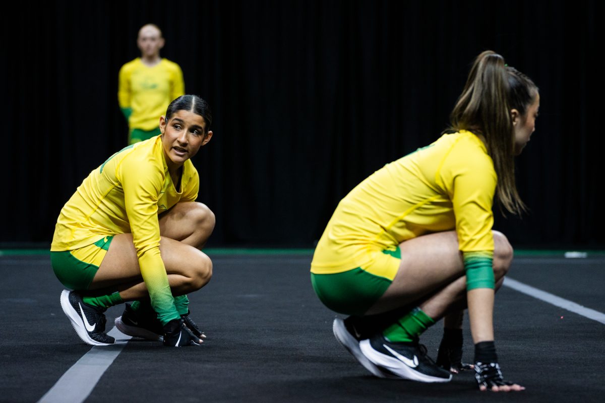 Alexis Giardina (29) looks back to the team before starting the final routine. The University of Oregon Ducks Women’s Acrobatics and Tumbling team in a home match against Morgan State at Matthew Knight Arena in Eugene, Ore., on Feb. 15, 2025. (Rowan Campbell/Emerald).