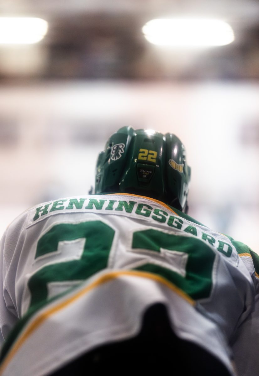 University of Oregon forward Jackson Henningsgard (22) watches the action from the bench. The University of Oregon Hockey team went up against the Rogue Valley Royals for Senior Night, and for the final game of the season March 1, 2025, at The Rink Exchange in Eugene, Ore. Ducks defeated the Royals 6-2. (Max Unkrich / Emerald)