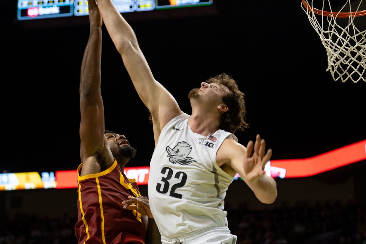 Ducks center Nate Bittle (32) jumps up to block a shot from the Trojans. Oregon men's basketball take on the University of Southern California Trojans at Matthew Knight Arena in Eugene, Ore. on Mar. 1, 2025 (Saj Sundaram/Emerald)